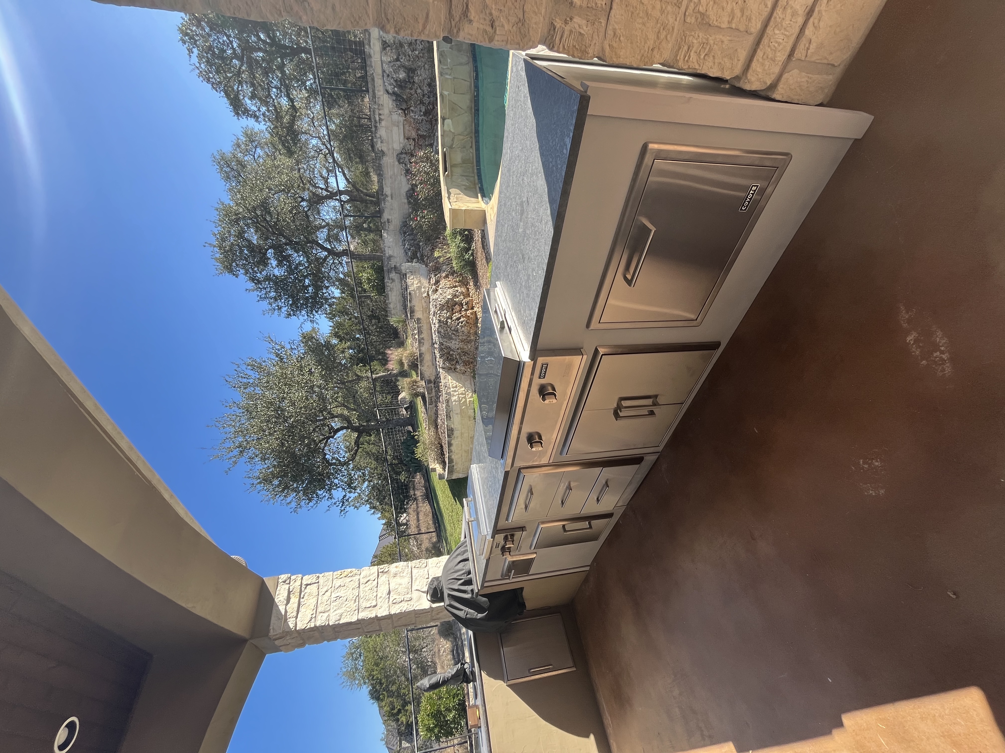 Coyote outdoor kitchen with pool view, Texas Hill Country